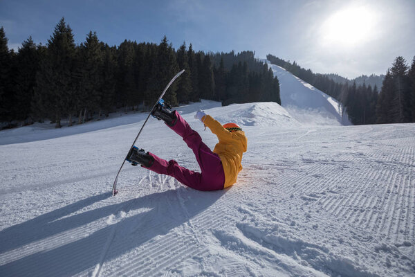 one young woman snowboarding in winter mountains