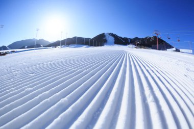 Kayak merkezinde snowcat bıraktığı bir yamaç satırları izlemek