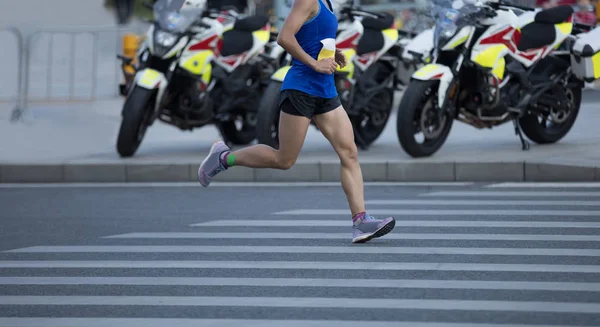 市道を走るマラソンランナーの足 — ストック写真