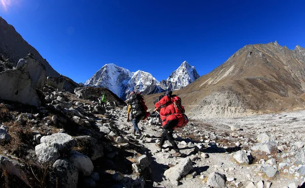 Nepalese carrying Luggage trekking on the way to Everest base camp, Nepal — Stock Image Nepalese Carrying Luggage Trekking Way Everest Base Camp Nepal Royalty Free Stock Images
