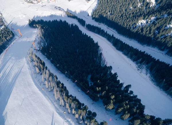 stock image Aerial view of the Alpine skiing and snowboarding piste in mountains