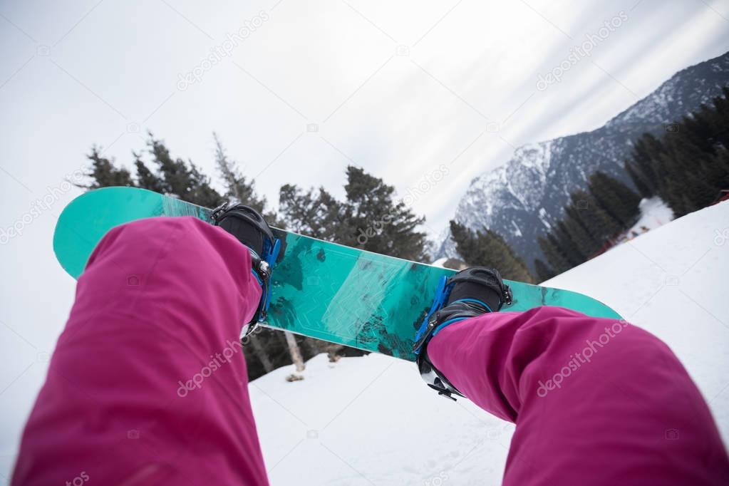 snowboarding legs in winter mountains