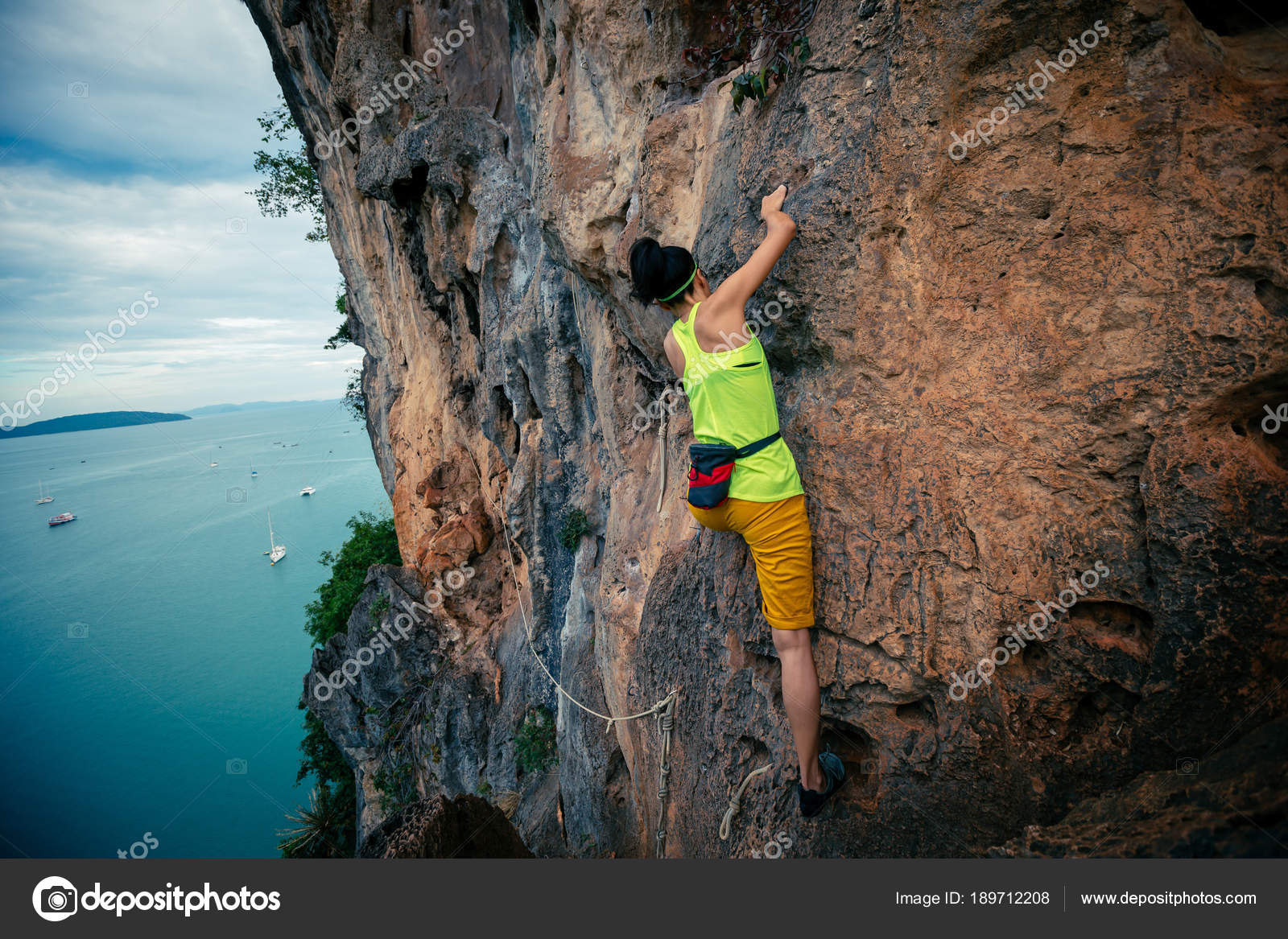 Female Rock Climber Climbing Seaside Cliff — Stock Photo © lzf 189712208