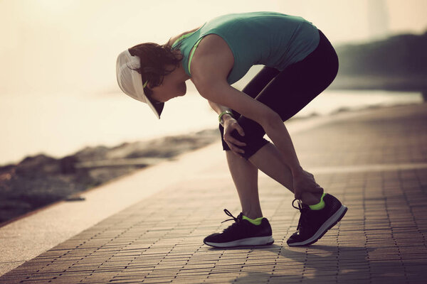woman runner with sports running knee injury 