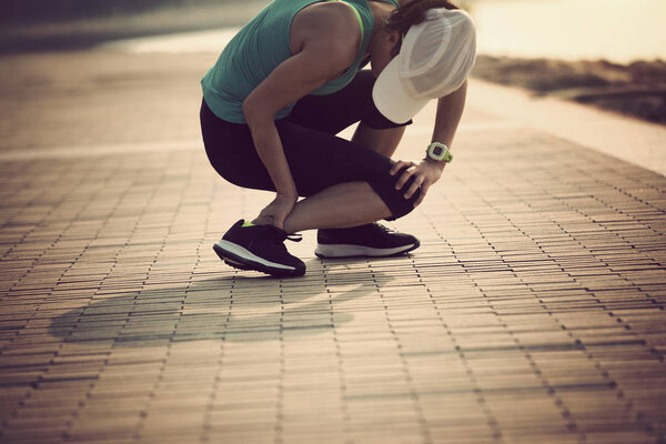 Woman runner with sports running legs injury