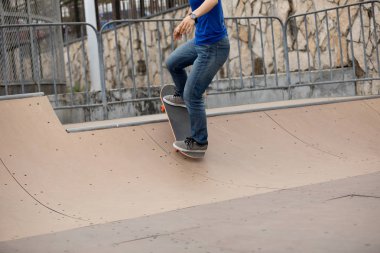 Genç kadın skatepark rampa üzerinde kaykay