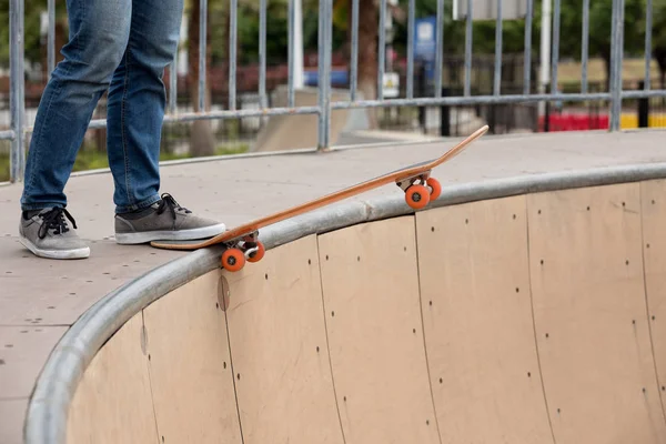 Cropped image of kateboarder practicing on skatepark ramp