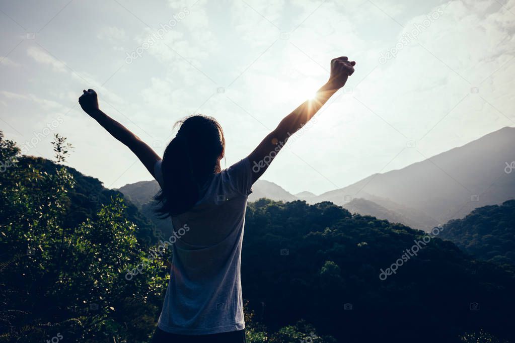 happy woman enjoying the view on morning mountain valley