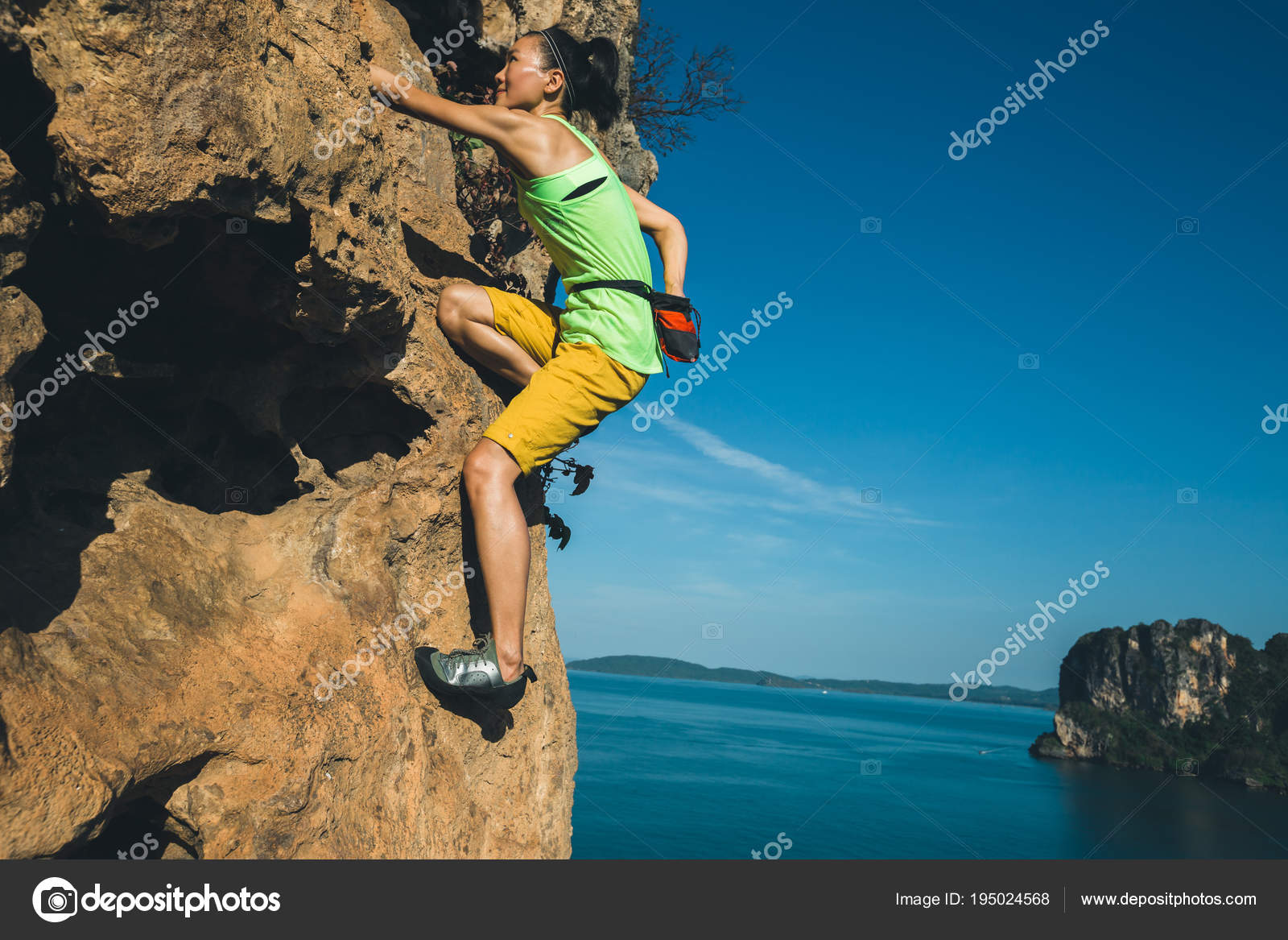 Female Rock Climber Climbing Seaside Cliff — Stock Photo © lzf 195024568