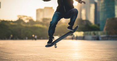 Gün batımında şehirde tanınmayan kadın kaykaycı.