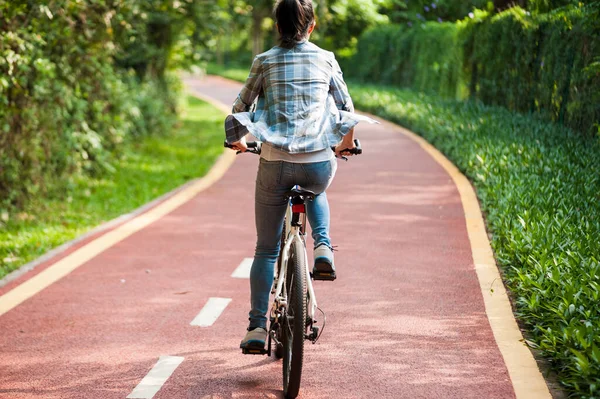 Female cyclist riding mountain bike in park