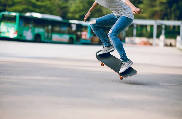 Skateboarder doing tricks with skateboard outdoors