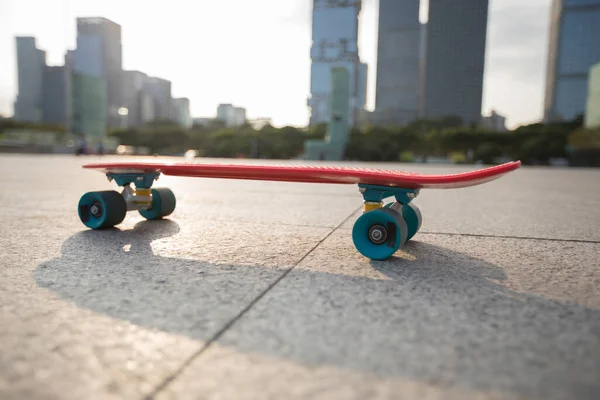 Skateboard Über Dem Sonnenuntergang Mit Städtischem Hintergrund — Stockfoto