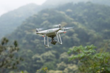 Bahar dağlarında uçan kameralı beyaz dron