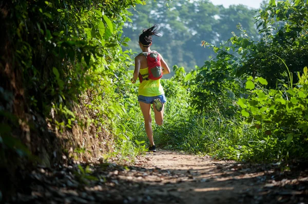年轻女子径赛选手在日出热带森林中奔跑 — 图库照片