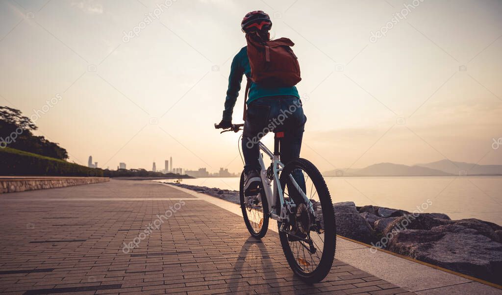 Cyclist riding mountain bike in the sunrise coast