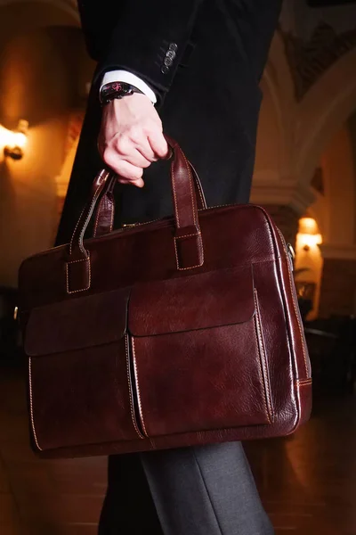 ビジネススーツの男とビジネスミーティングで茶色の革のブリーフケースを着た長いコート ストック写真