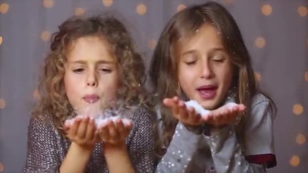 Twee Kleine Meisjes Blazen Valse Sneeuwvlokken Camera Kerst Bokeh Lichten — Stockvideo