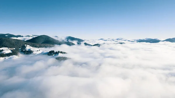 Dağların tepeleri kar ve bulutlarla kaplı güzel bir manzara. — Stok fotoğraf