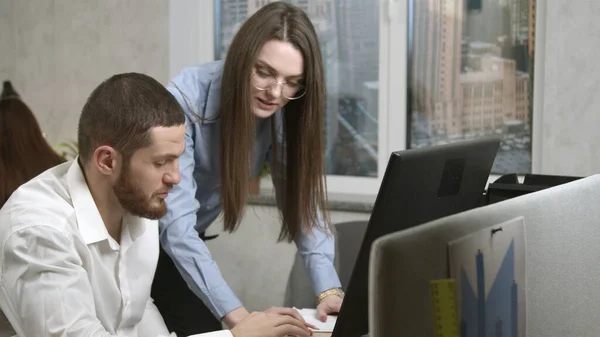 Mujer joven dando explicaciones a su compañero de trabajo — Foto de Stock