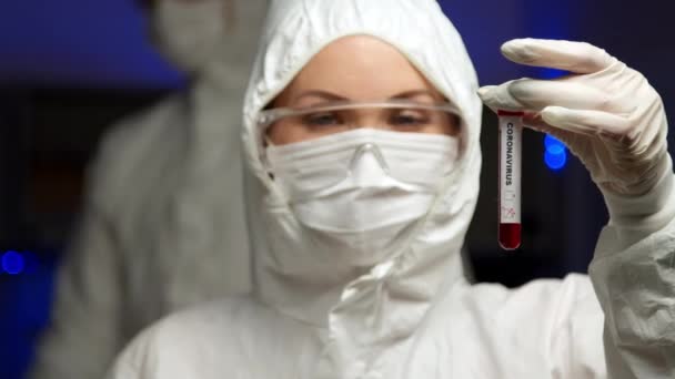 Scientist holding Coronavirus test sample — стокове відео