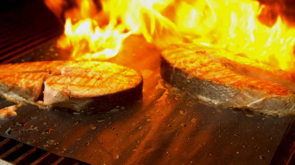 Salmon fish cuts being grilled with fire — Stock Photo, Image