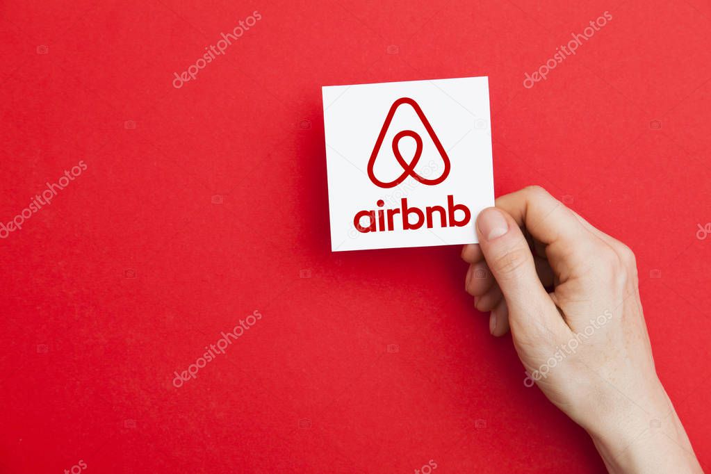 LONDON, UK - May 7th 2017: Hand holding Airbnb logo. Airbnb is a popular online home vacation rental company