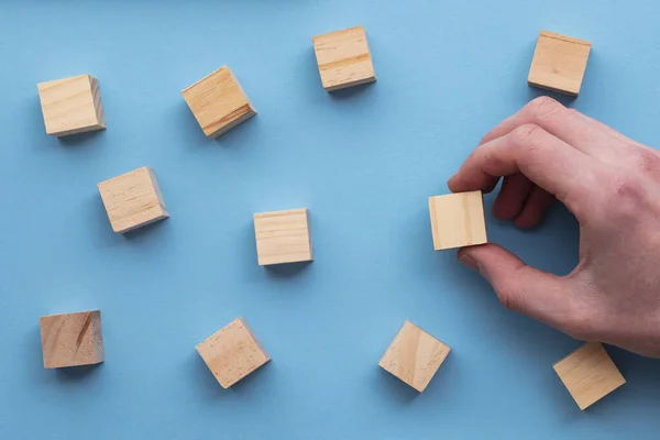 Рука вибирає дерев'яний блок з набору. Концепція вибору бізнесу — стокове фото