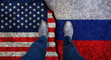 İşadamı, Usa ve Rusya 'nın çatlak bayraklarının üzerinde duruyor. Siyasi kavram