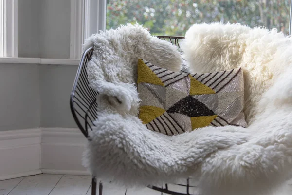 Modern armchair covered in soft furnishings in a bright room — Stock Photo, Image