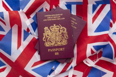 United Kingdom travel passport on a Great Britain Union Jack flag clipart