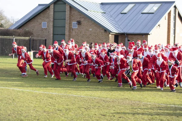 Оксфордшир, Великобритания - 14 декабря 2019 года: Люди, одетые как Дед Мороз, принимают участие в ежегодном веселом пробеге Санта-Клауса . — стоковое фото