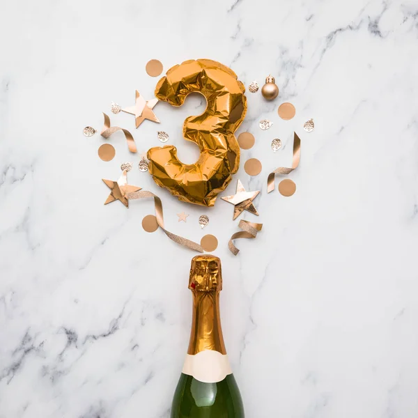Champagne bottle with gold number 3 balloon. Minimal party anniversary concept