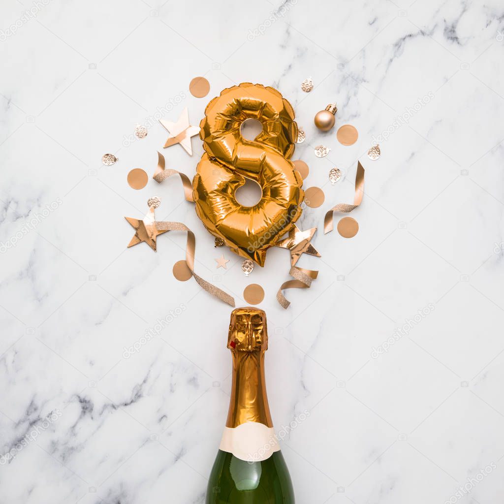 Champagne bottle with gold number 8 balloon. Minimal party anniversary concept