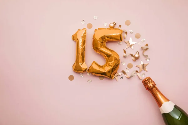 Happy 15th anniversary party. Champagne bottle with gold number balloon. — Stock Photo, Image