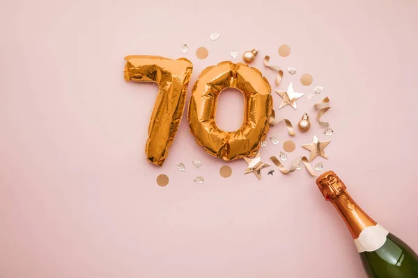 Feliz aniversário de 70 anos. Garrafa de champanhe com balão número de ouro . — Fotografia de Stock