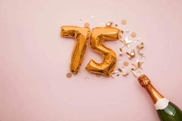 Joyeux 75e anniversaire. Bouteille de champagne avec ballon numéro or . — Photo