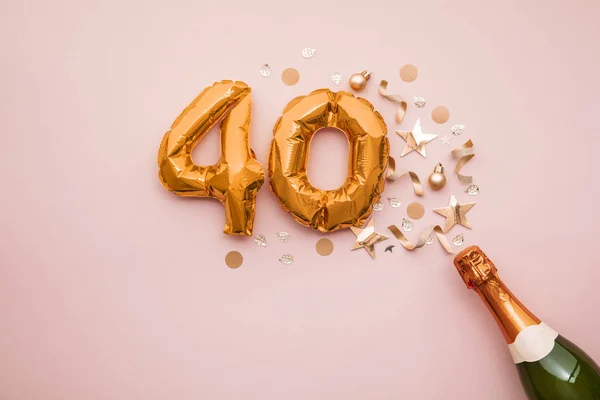Happy 40th anniversary party. Champagne bottle with gold number balloon. — Stock Photo, Image