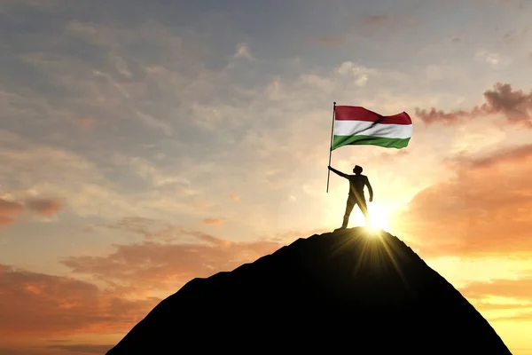 Hungarian flag being waved at the top of a mountain summit. 3D Rendering — Stockfoto