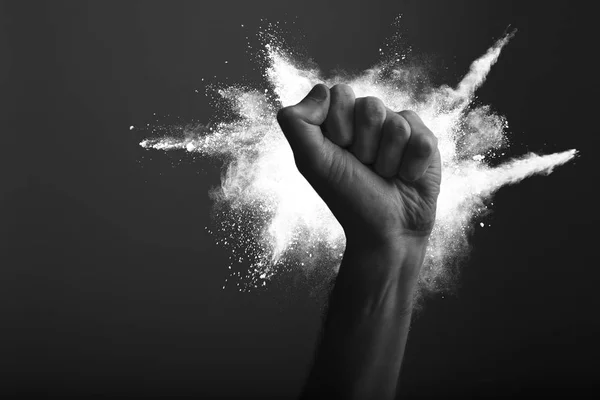 Raised clenched fist with white powder explosion, power, protest concept — Stock Photo, Image