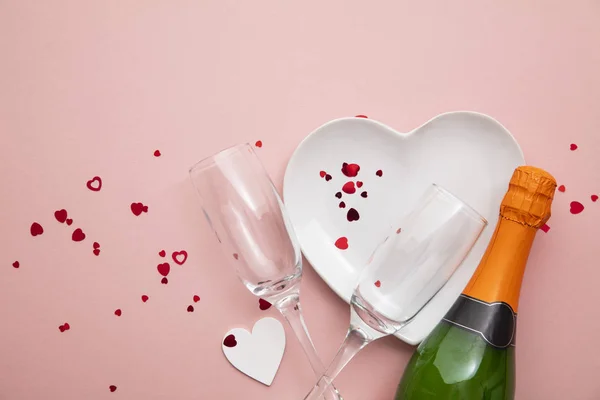 Romantisk måltid bakgrund. Hjärtformad tallrik med champagne och glas — Stockfoto