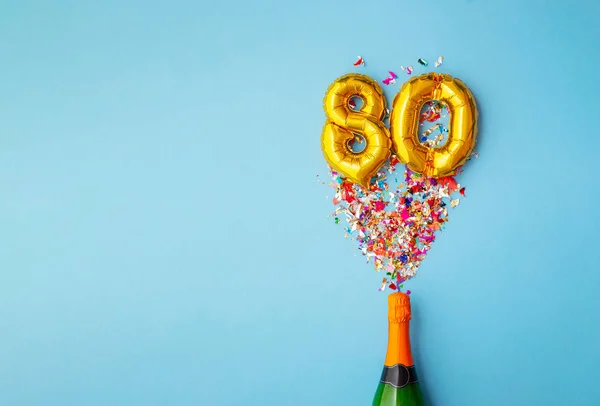 80e anniversaire bouteille de champagne ballon pop — Photo