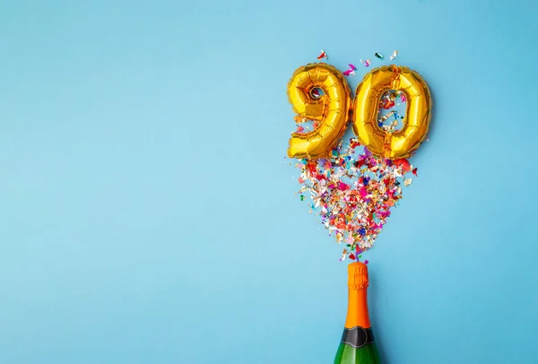 90-jarig bestaan champagne fles ballon pop — Stockfoto