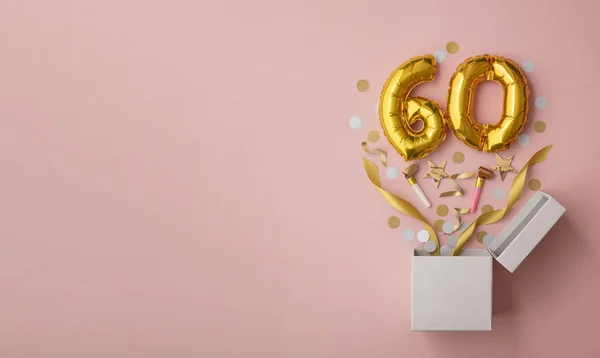 Nummer 60 födelsedagsballong fest presentförpackning låg platt explosion — Stockfoto