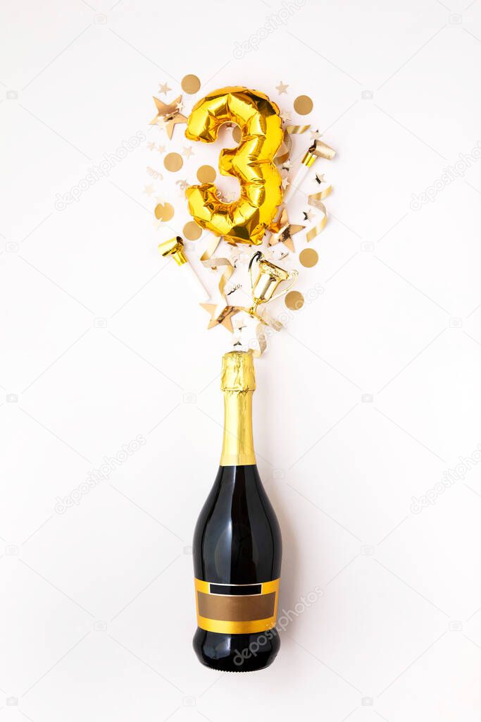 Happy 3rd anniversary party. Champagne bottle with gold number balloon.