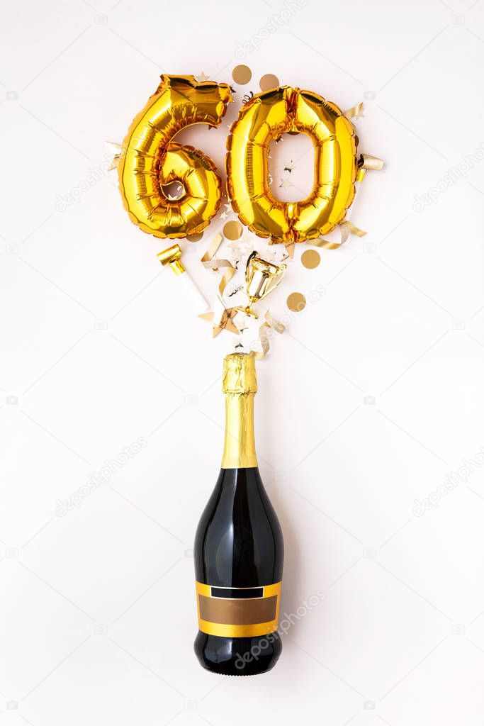 Happy 60th anniversary party. Champagne bottle with gold number balloon.