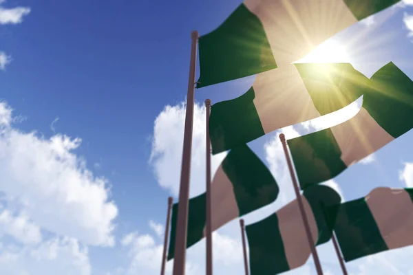 Bandeiras da Nigéria acenando ao vento contra um céu azul. Renderização 3D — Fotografia de Stock