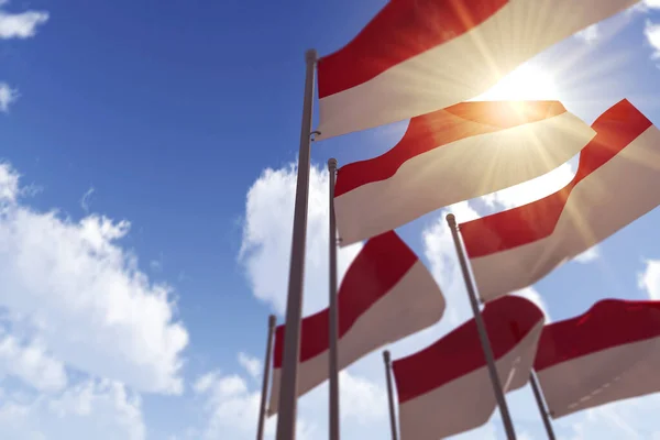 Bandeiras da Indonésia acenando ao vento contra um céu azul. Renderização 3D — Fotografia de Stock