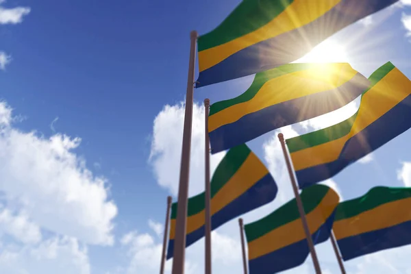 Bandiere del Gabon sventolano nel vento contro un cielo blu. Rendering 3D — Foto Stock