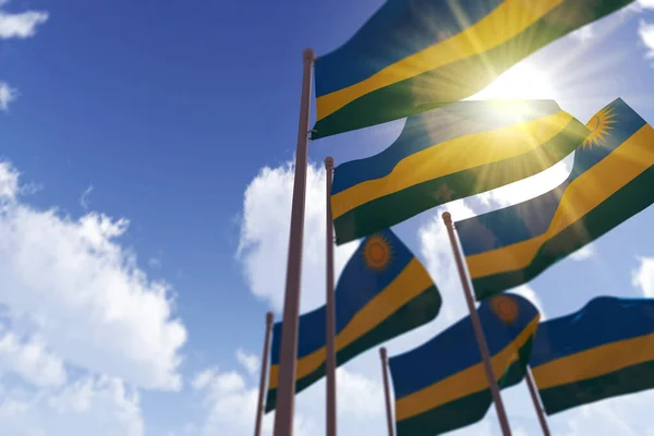 Bandeiras de Ruanda acenando ao vento contra um céu azul. Renderização 3D — Fotografia de Stock